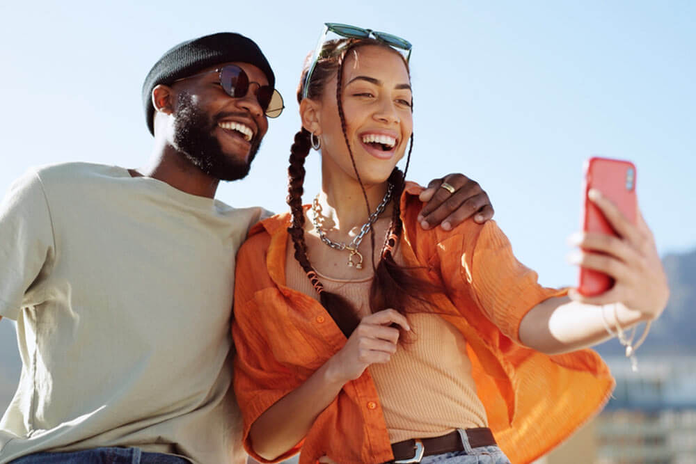 Couple, bonding and phone selfie on city building rooftop on New York summer holiday