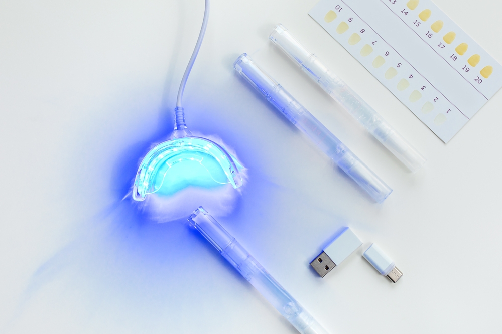 teeth whitening kit at home with LED lamp, on a white background, snow-white smile, dental care, dentistry
