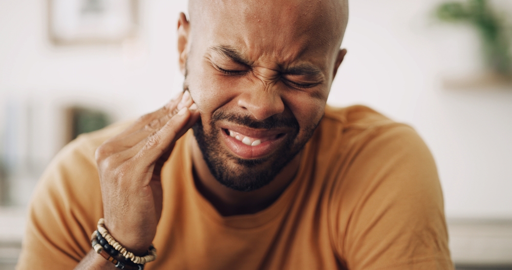 Toothache, sensitive and man in house with dental problem