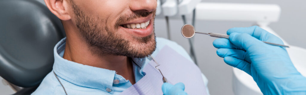 Patient receiving a dental examination with instruments at a dental office