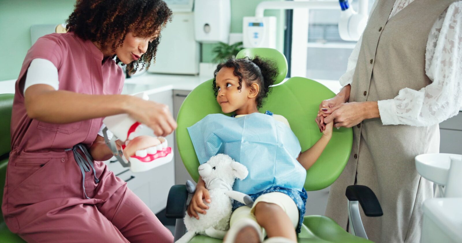 Dentist, consulting and woman with child in clinic for tooth extraction, cleaning and wellness.