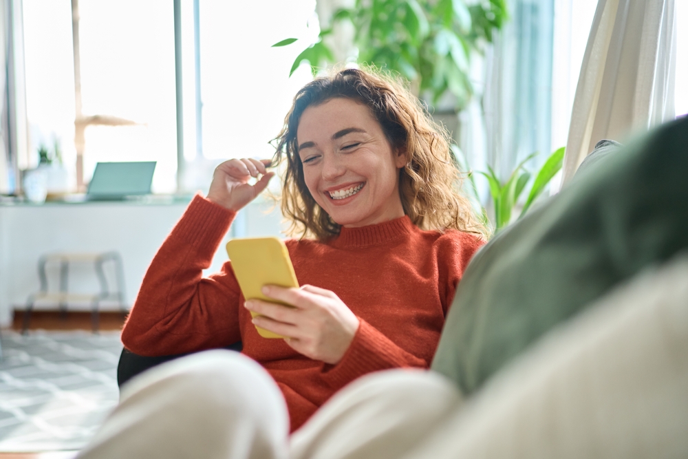 Young Relaxed Woman Sitting On Couch