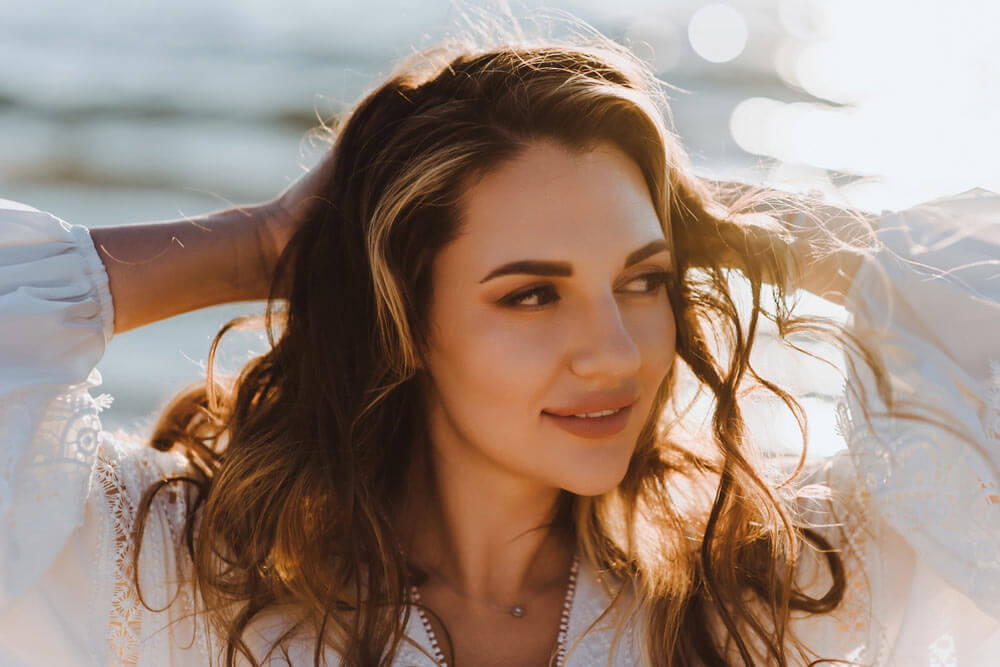 happy smiling cheerful young woman model on the beach