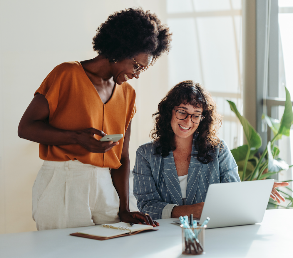 Two female using a laptop