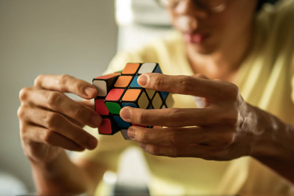 A man solving rubik's cube.