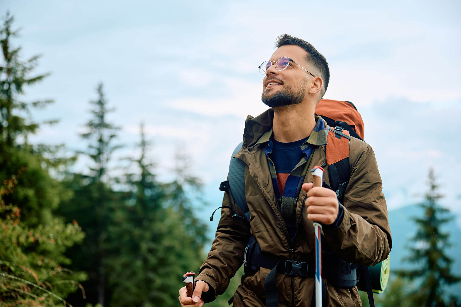 Young happy man hiking in the mountains.