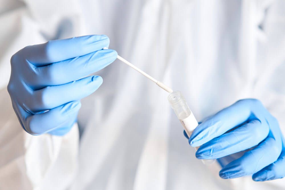 Doctor holding swab test tube