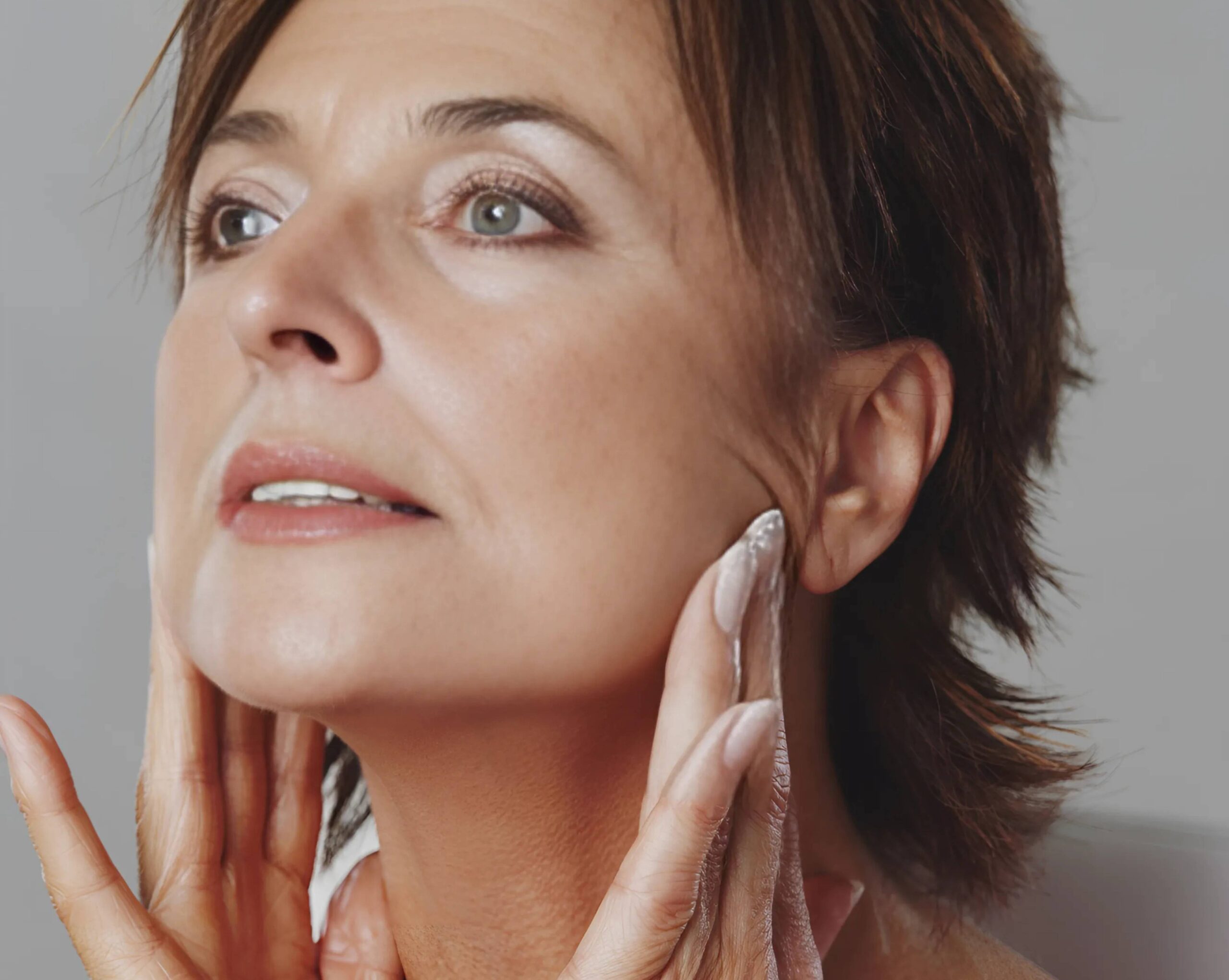 Woman examining her jaw for bone loss