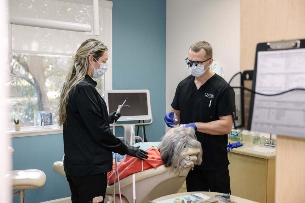 Caring, gentle dentistry in Cape Coral Florida, Dr. Klamut and his Assistant working on a patient