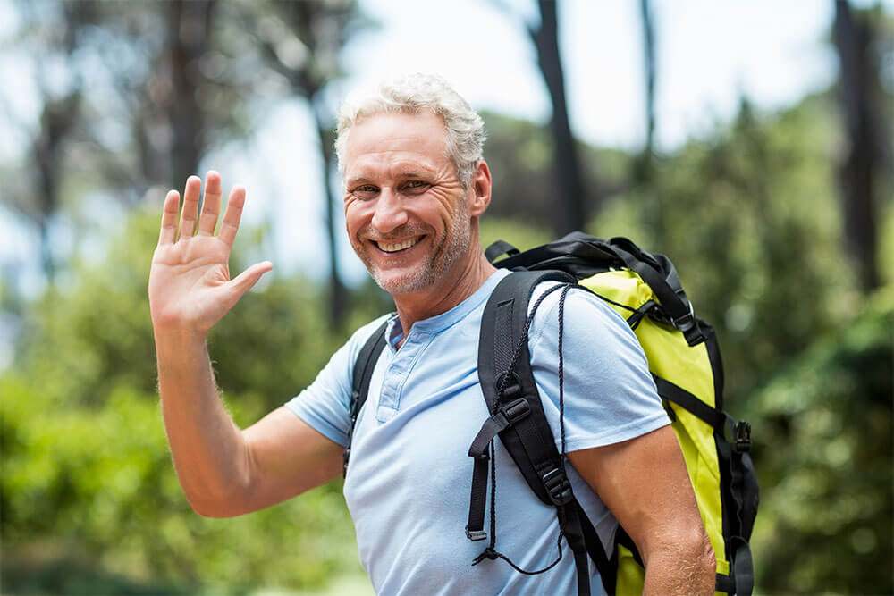 man smiling and greeting