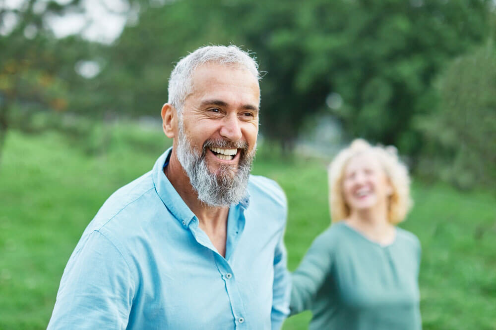 Happy active mid aged adult couple having fun