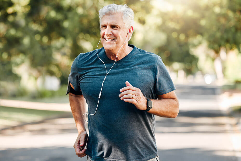 Senior man running while listening to music