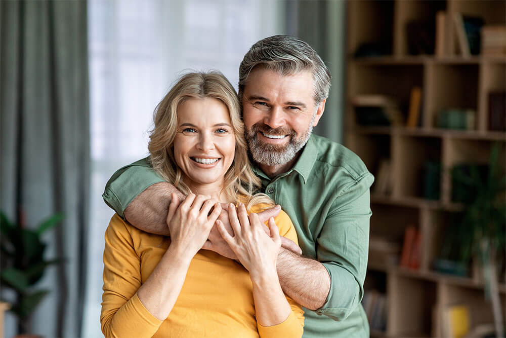 Loving Middle Aged Spouses Embracing And Smiling