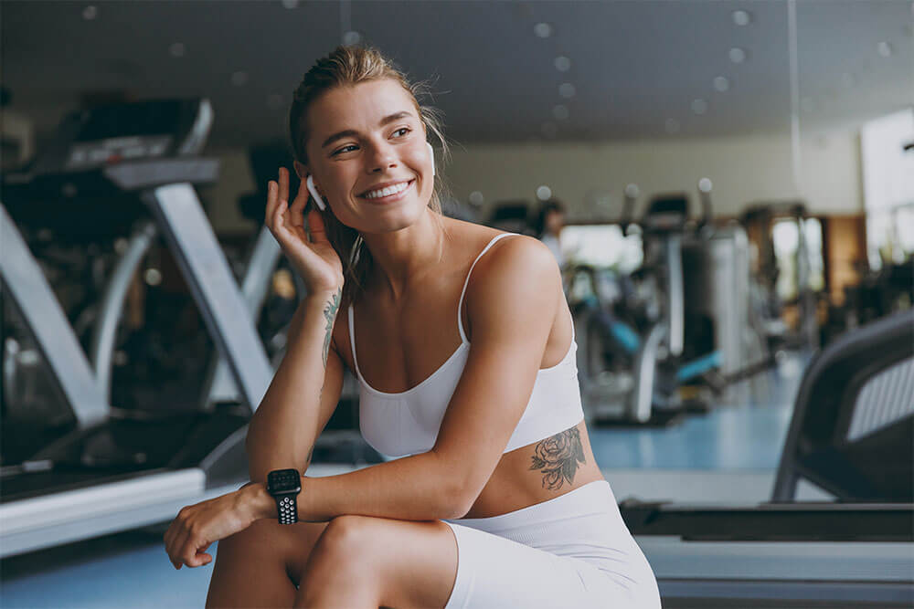 Young dreamful sportswoman woman