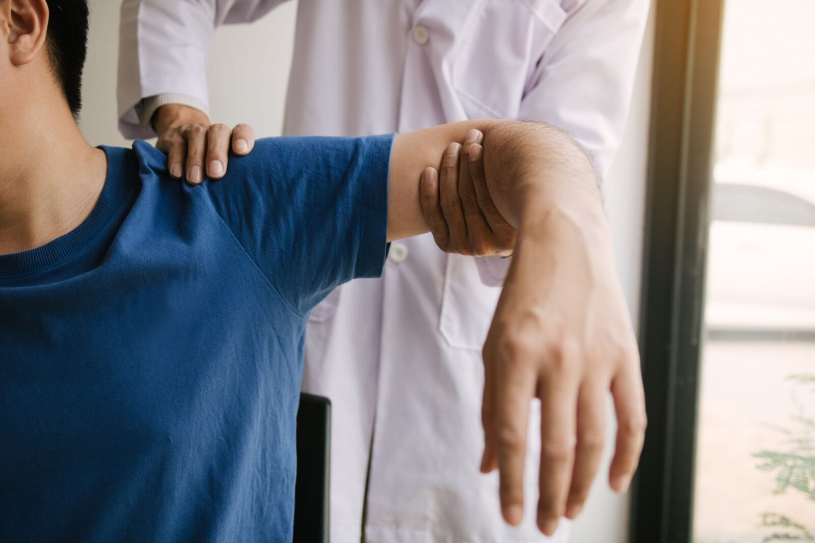 Physical therapists press to the patient shoulder checking for pain