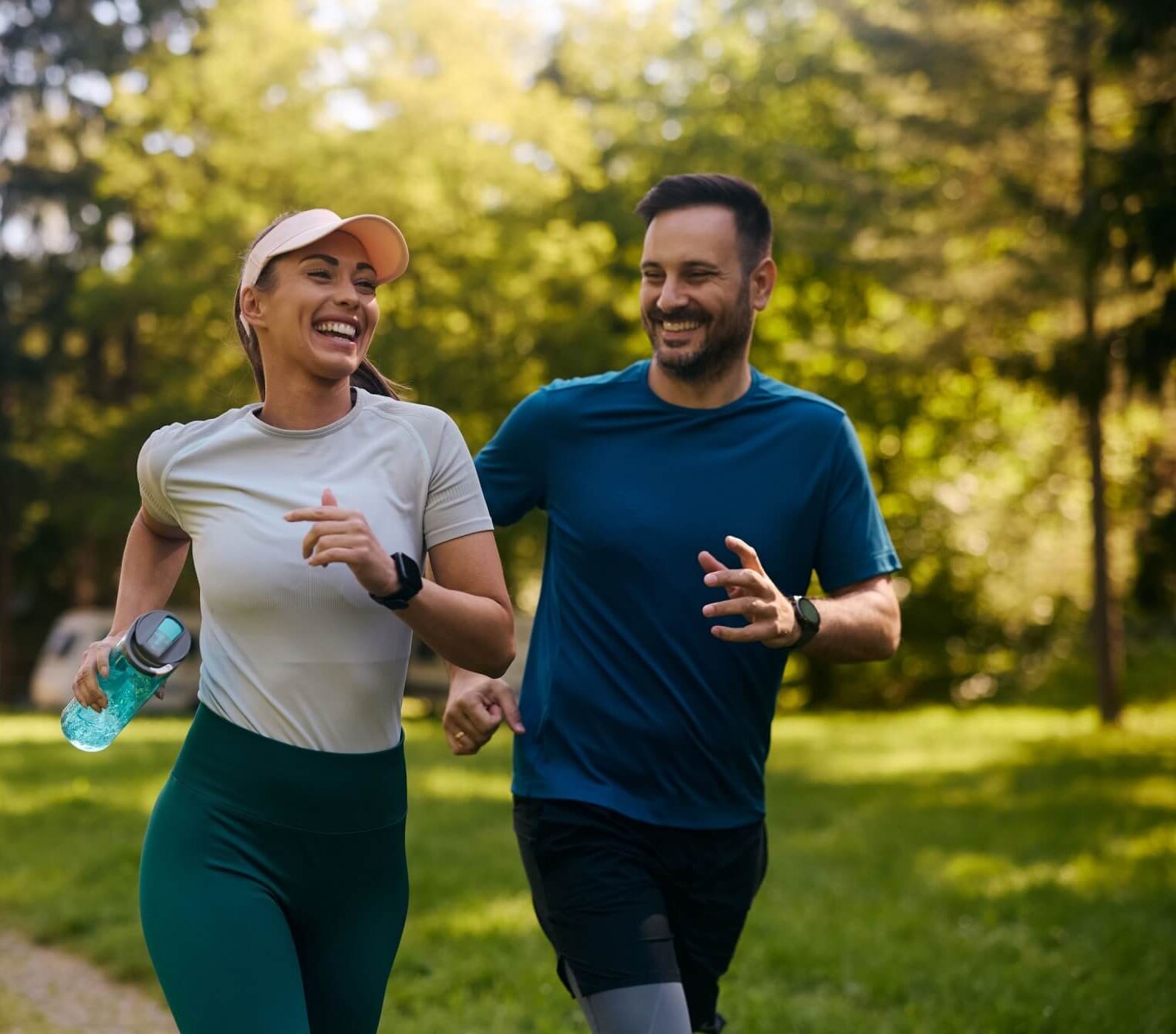 Happy athletic couple having fun while running