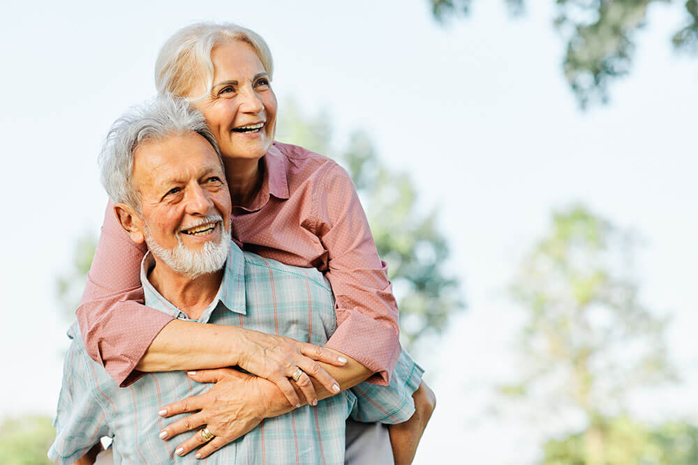Happy active senior couple having fun outdoors