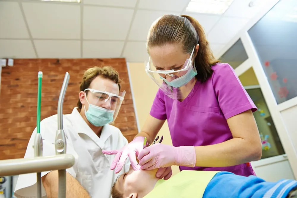 dentist treat boy teeth under sedation