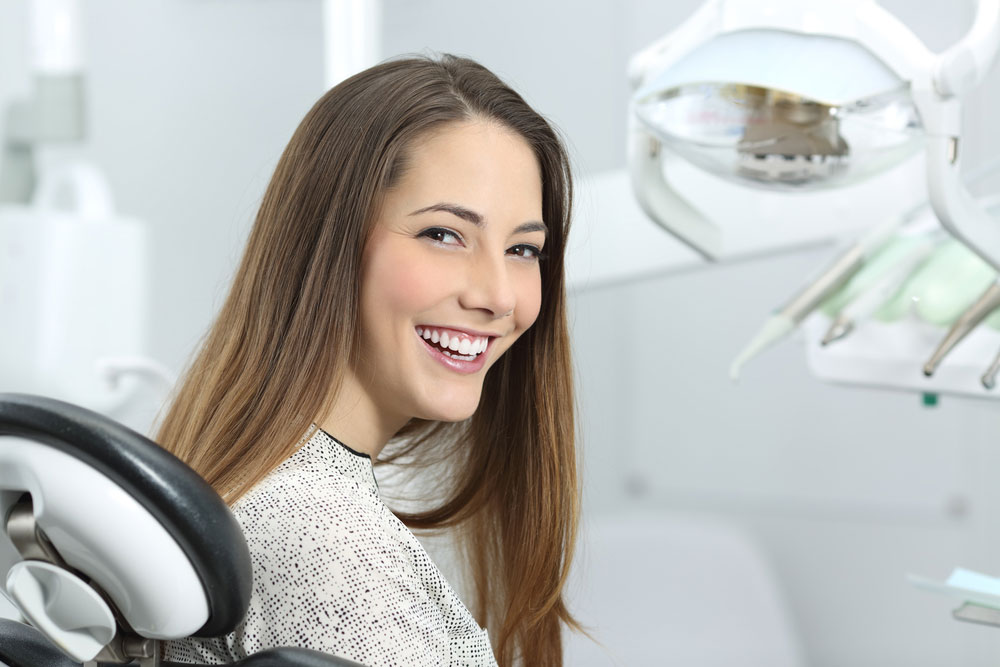 Satisfied dentist patient showing her perfect smile