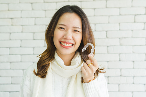 Woman holding orthodontic silicone trainer