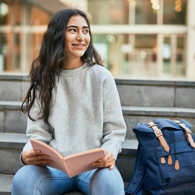 student girl smiling happy reading book