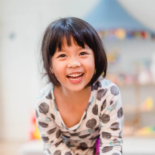 Happy Little girl showing front teeth with big smile