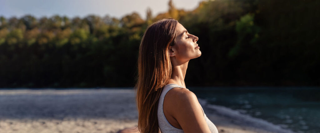 Young woman with long hair enjoying sun w