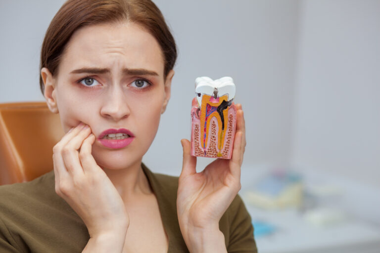 Young,Woman,Suffering,From,Toothache,,Looking,To,The,Camera,In