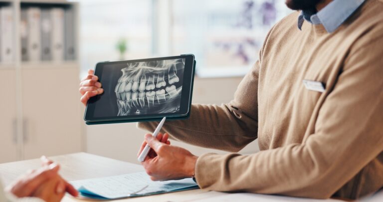 Dentist hands, tablet and xray on screen for help, explain surgery or diagnosis with patient in office