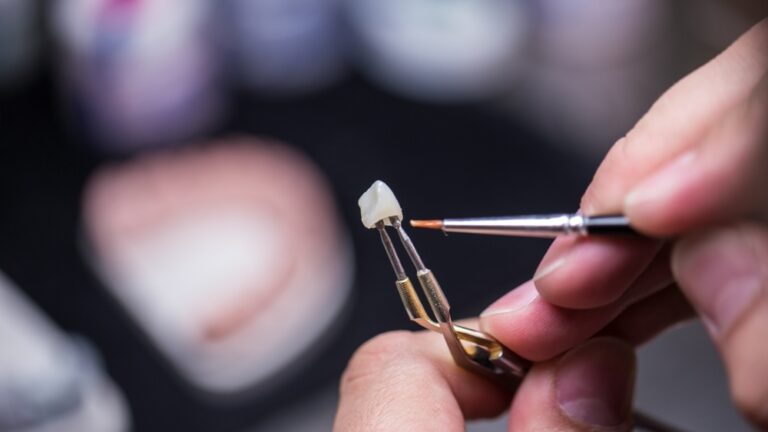 A Skilled Artisan Creating a Dental Restoration Piece with Precision Tools in a Modern Dental Laboratory Setting for Customized Patient Care