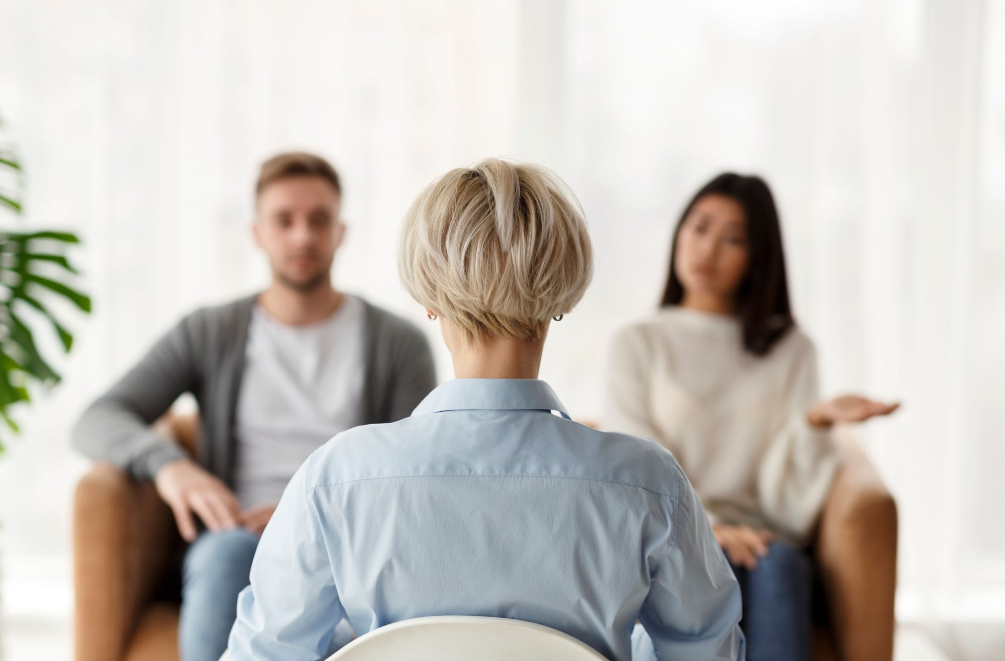 Psychologist Sitting During Appointment With Unhappy Couple In Office