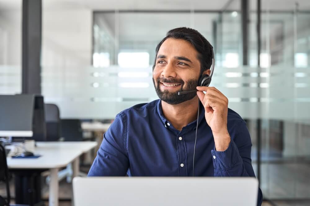 Smiling happy Indian call center agent