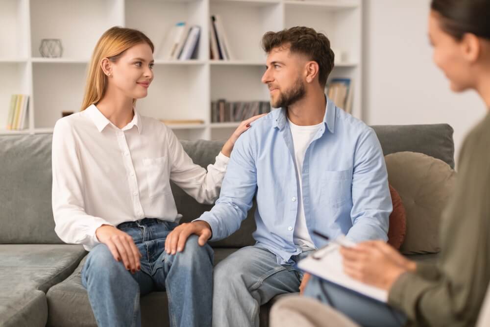 European husband and wife reconciling after successful marriage therapy session