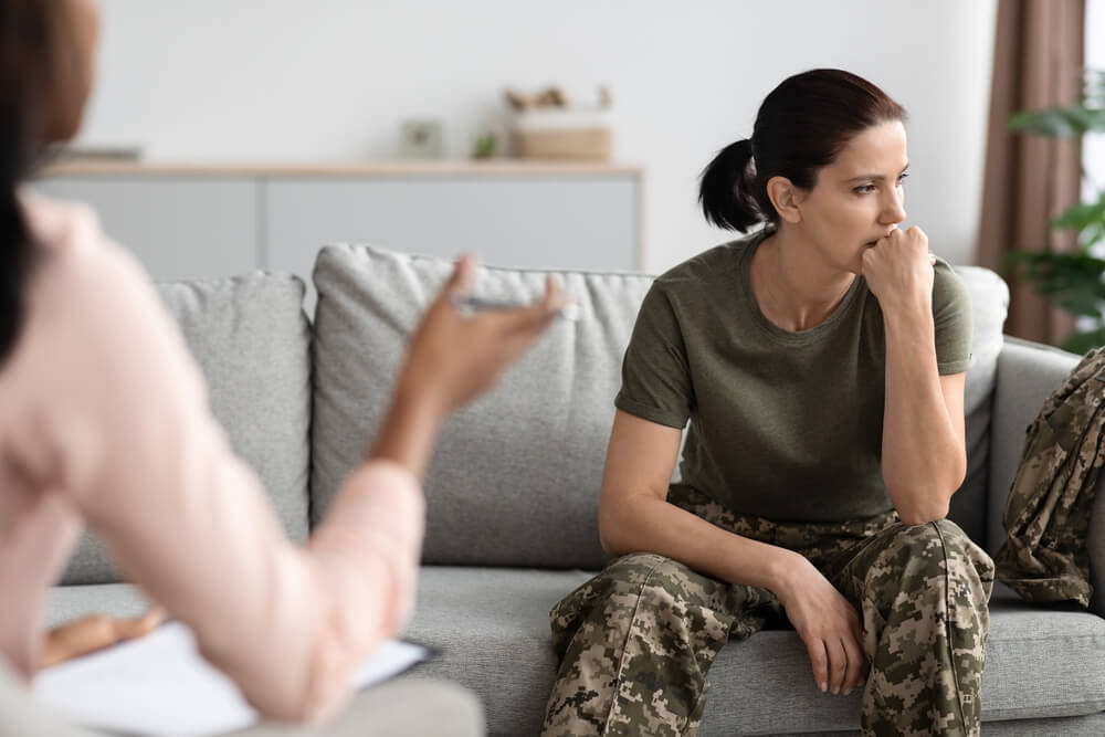 Upset Pensive Female Soldier Attending Meeting With Psychologist