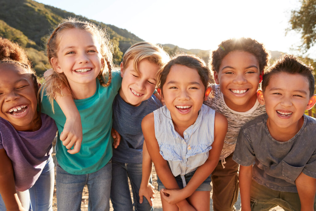 Group of diverse teenagers smiling and looking at camera