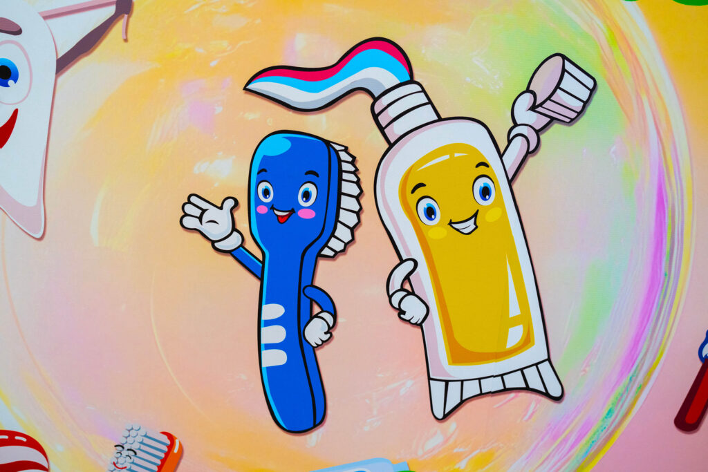 Office tour photos showing office artwork of blue toothbrush and yellow toothpaste with animated faces smiling