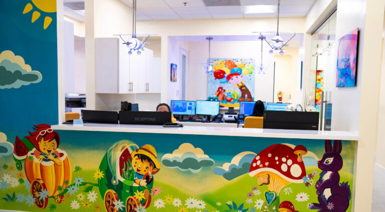 Office tour photos showing front desk with females working on computers