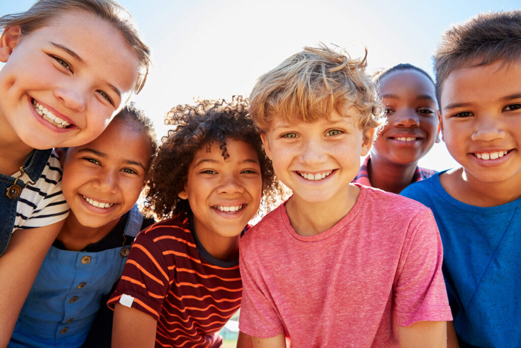 Group of diverse kids smiling and looking at camera