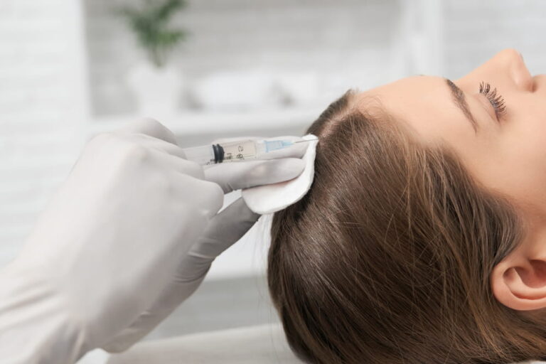 Side view of young brunette woman on procedure for improvements hair condition with special cosmetics