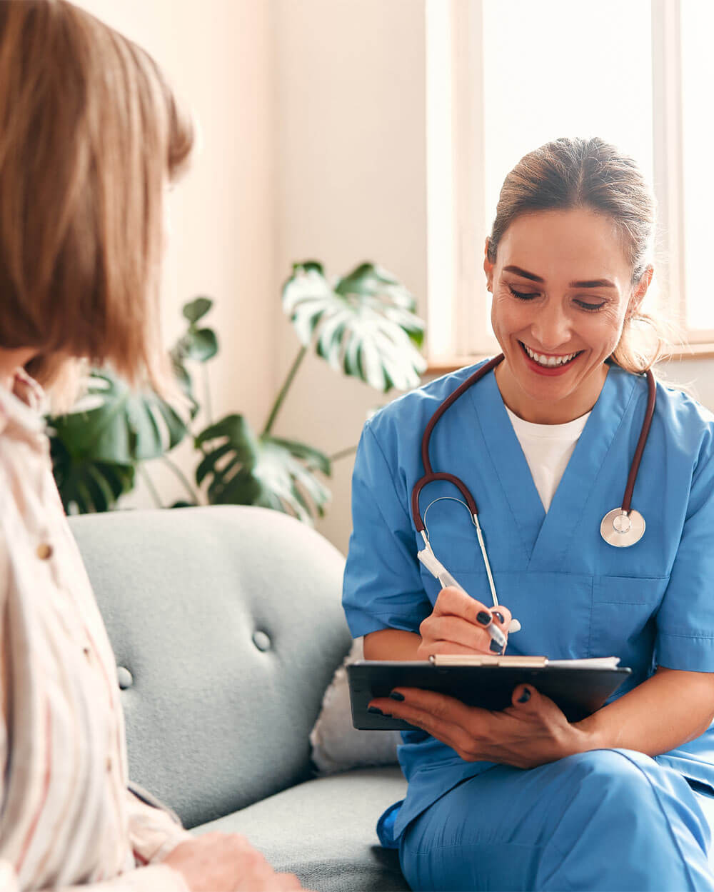 Young female nurse providing medical service to patient