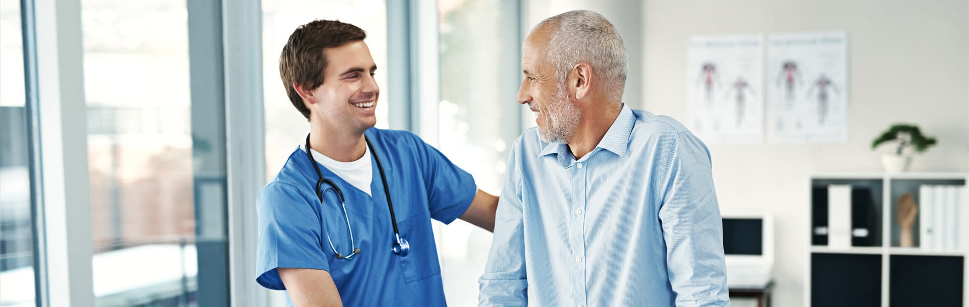 Nurse helping man with walker for support