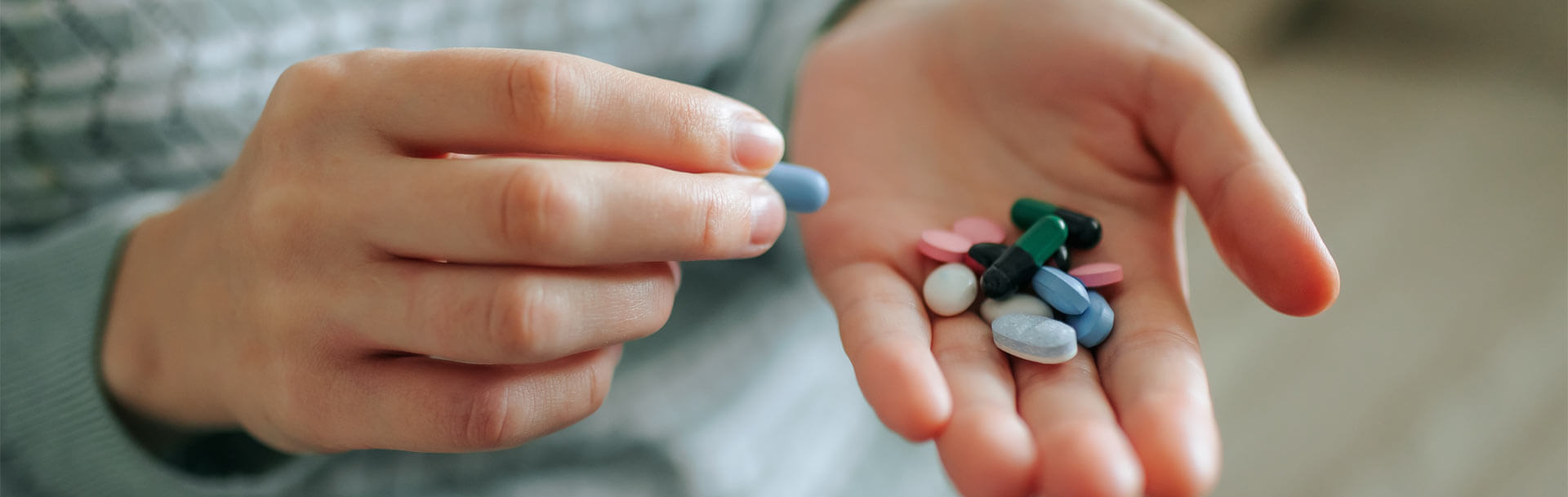 bunch of pills in her hand of a woman