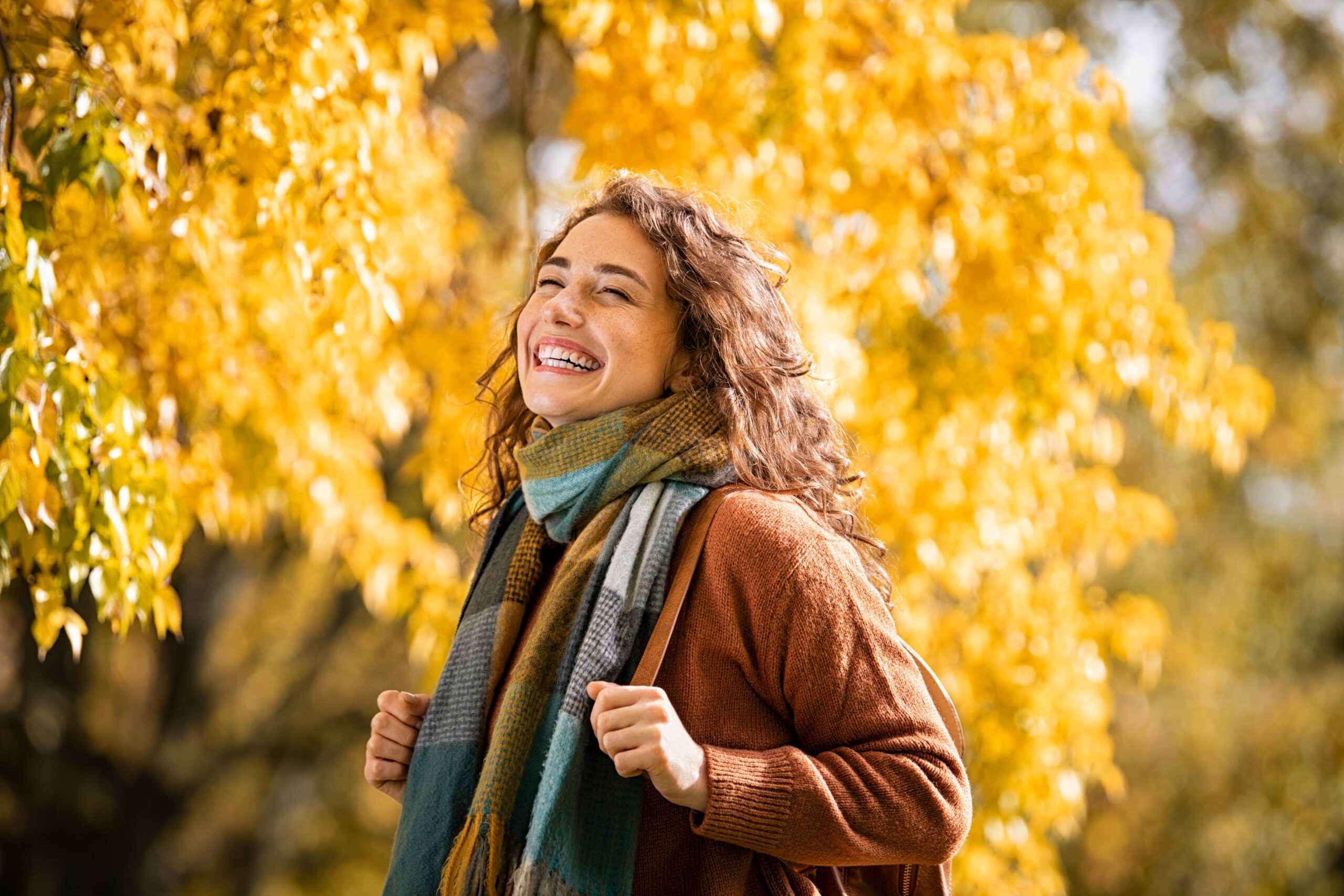 Cheerful young woman with winter scarf