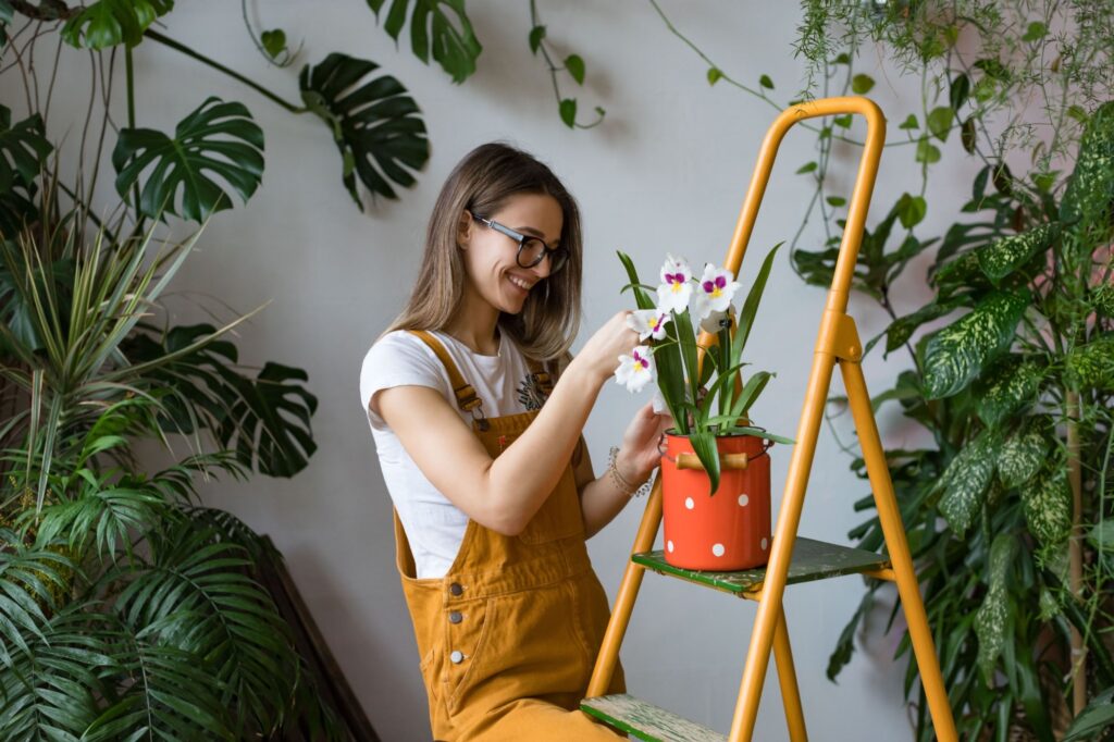 Young smiling woman gardener in glasses