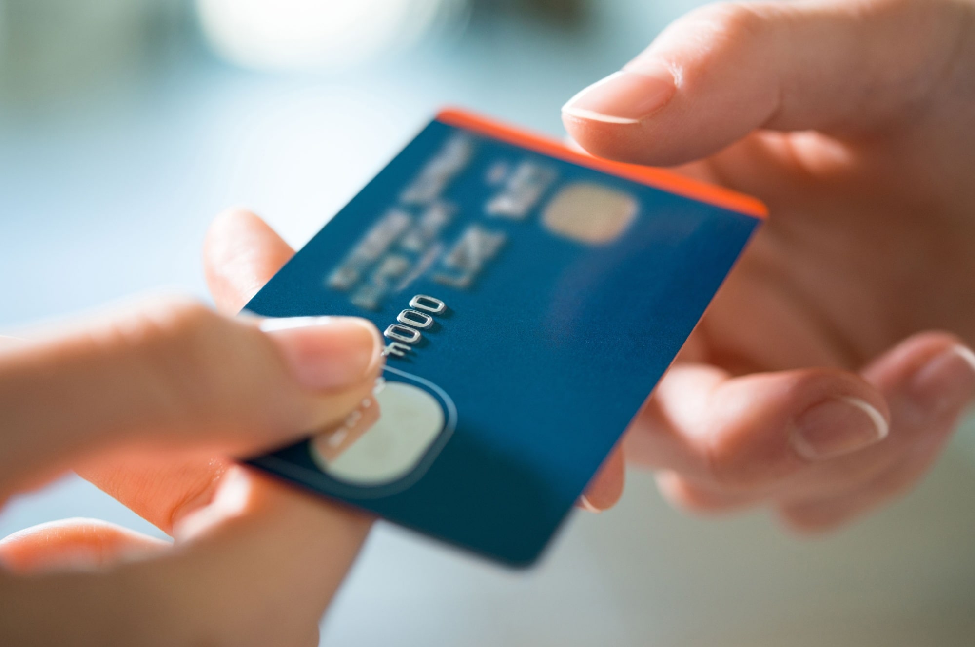 Woman passing a payment credit card to the seller