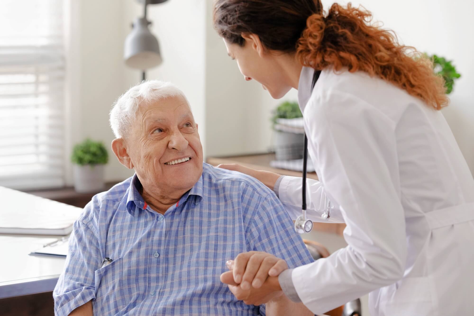 doctor wearing uniform comforting and supporting senior man