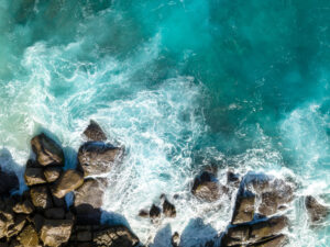 Waves crashing on rock cliff