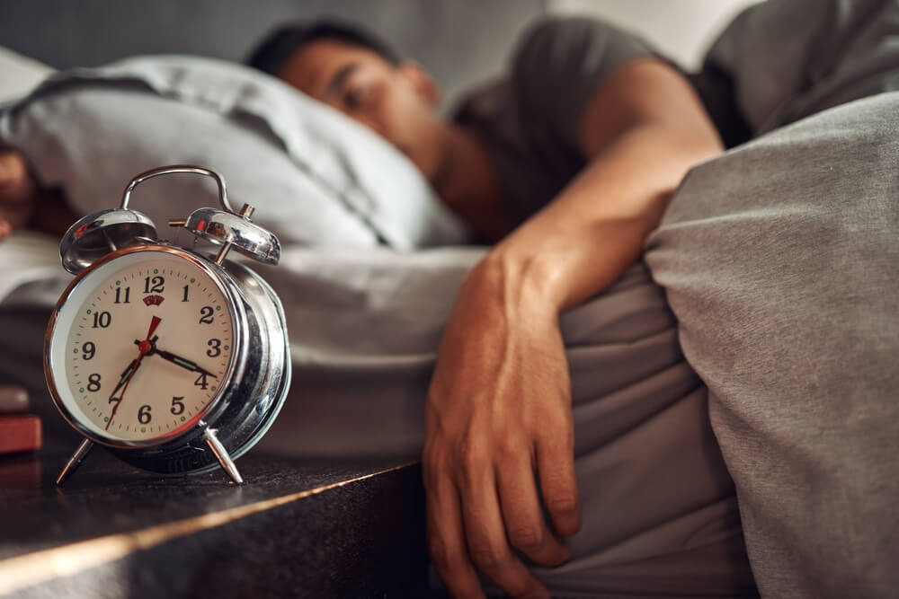 Alarm clock, relax and man sleeping