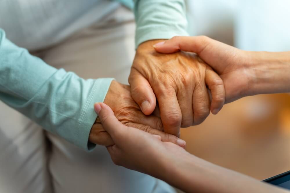 woman doctor consoling senior patient