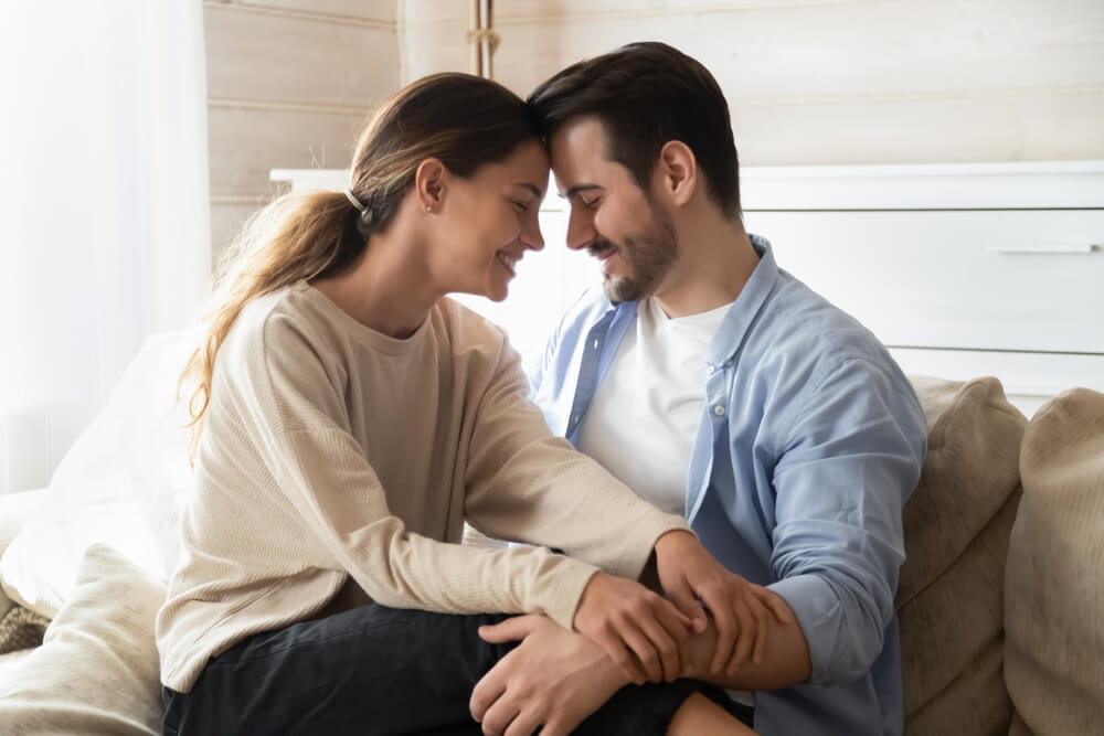 Happy loving man and woman enjoying tender moment